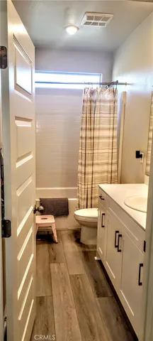 a bathroom with a granite countertop sink and a large mirror