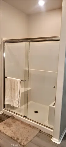 a bathroom with a glass shower door