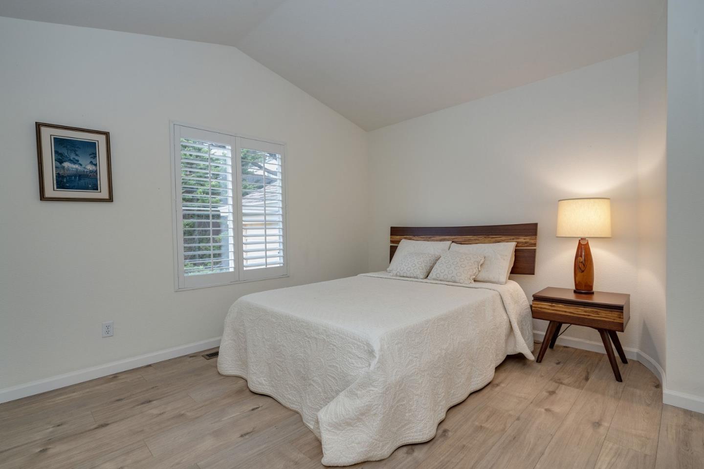 120 Patrick Way Half Moon Bay, CA 94019 - Photo 15 of 22 a bedroom with a bed and a lamp next to a window