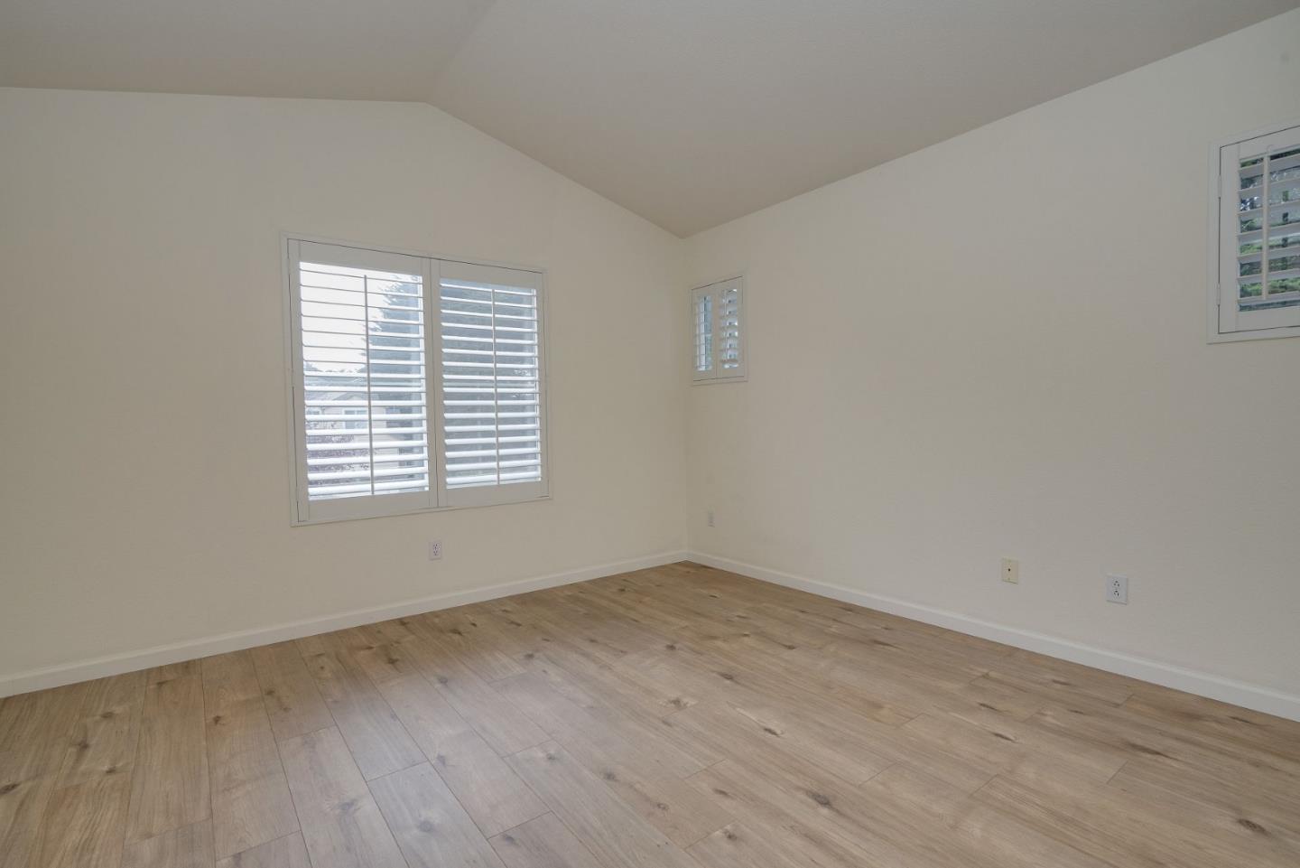 120 Patrick Way Half Moon Bay, CA 94019 - Photo 17 of 22 an empty room with wooden floor and windows