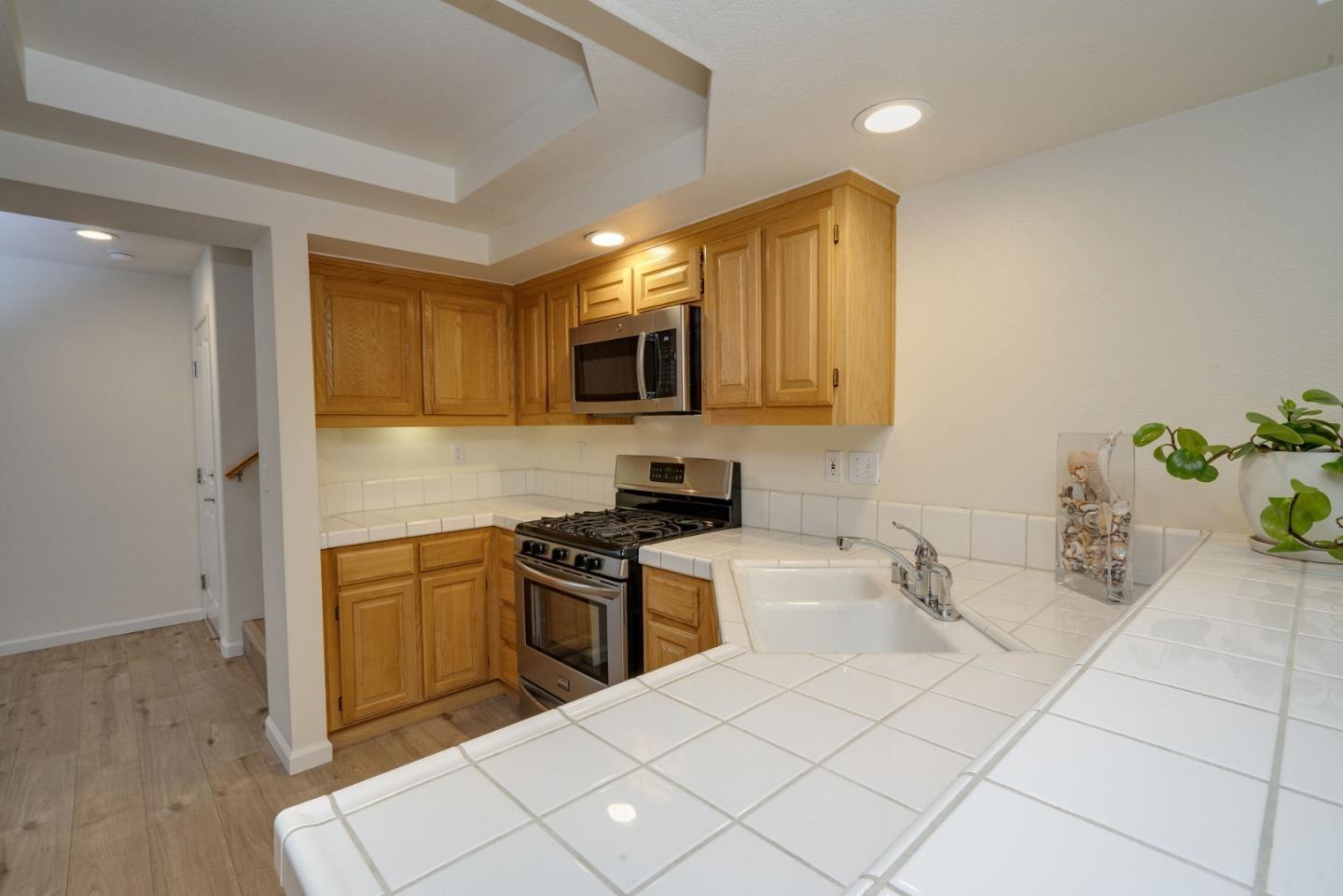 120 Patrick Way Half Moon Bay, CA 94019 - Photo 9 of 22 a kitchen with stainless steel appliances a sink a stove cabinets and a counter top space