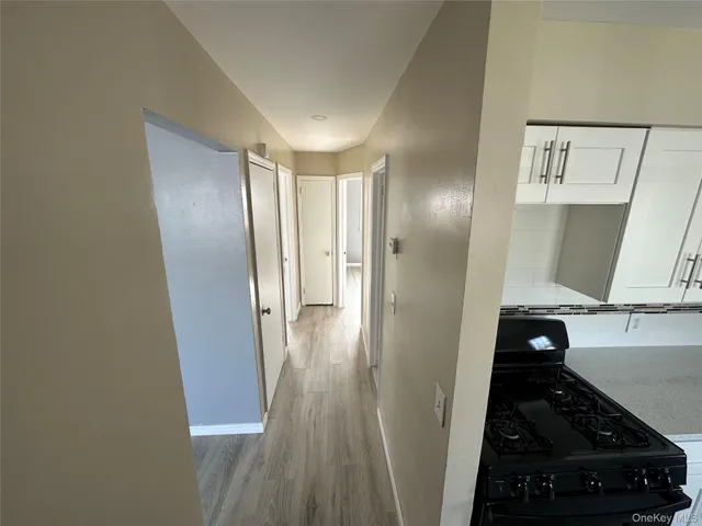 a view of a hallway and wooden floor