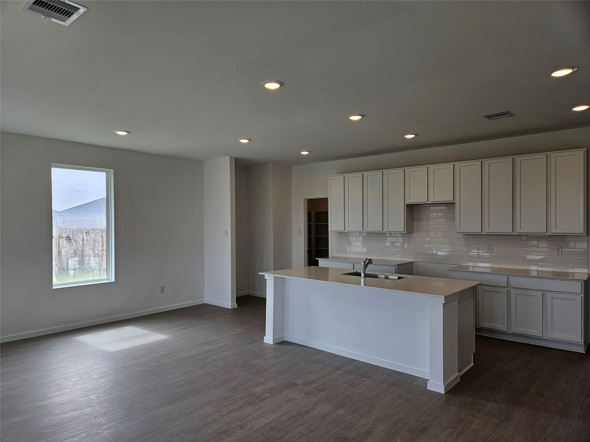 7823 Evening Emerald Drive Rosharon, TX 77583 - Photo 2 of 8 a kitchen with stainless steel appliances granite countertop a sink a stove a refrigerator a microwave oven with white cabinets