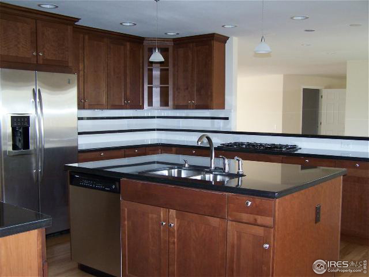 8747 Baseline Road Lafayette, CO 80026 - Photo 3 of 12 a kitchen with a sink and cabinets