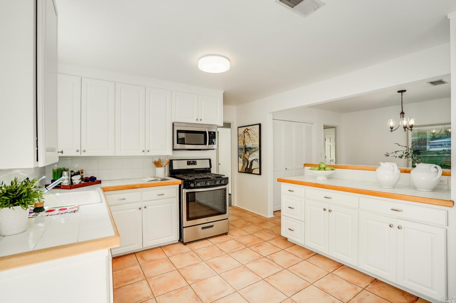 78 Nelson Avenue Mill Valley, CA 94941 - Photo 15 of 21 a kitchen with white cabinets sink and stainless steel appliances