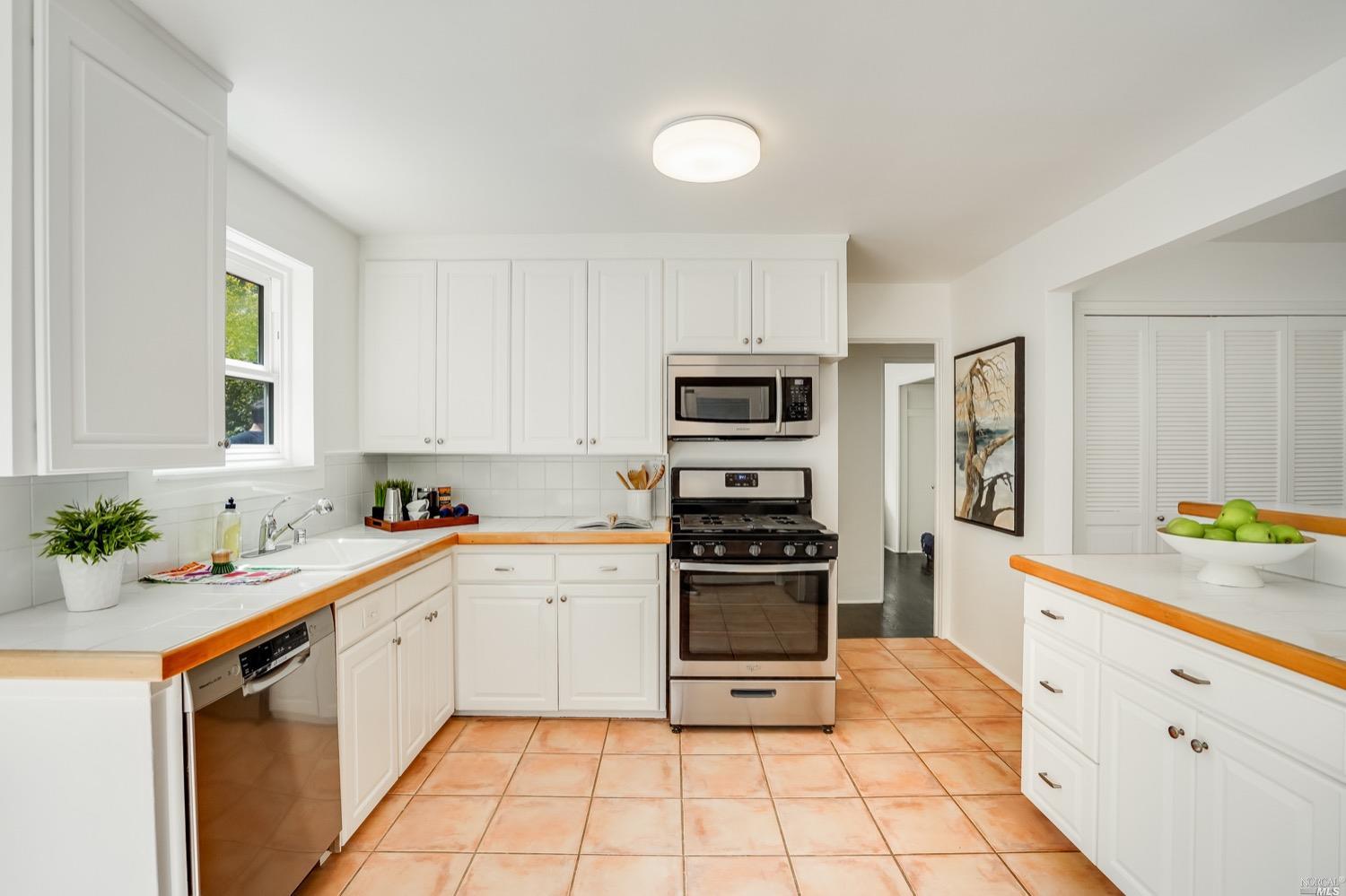78 Nelson Avenue Mill Valley, CA 94941 - Photo 16 of 21 a kitchen with a sink cabinets stainless steel appliances and a window