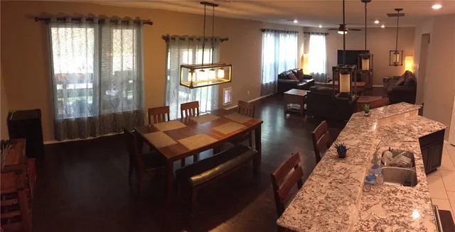 a living room with fireplace furniture and a chandelier