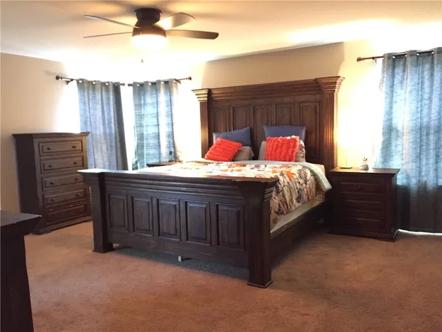 a bedroom with a bed and a mirror