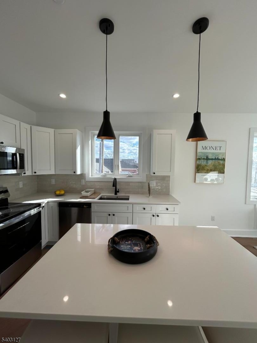 1225 Morris Avenue, Unit 204 Union, NJ 07083 - Photo 2 of 12 a kitchen with a sink a stove and chairs