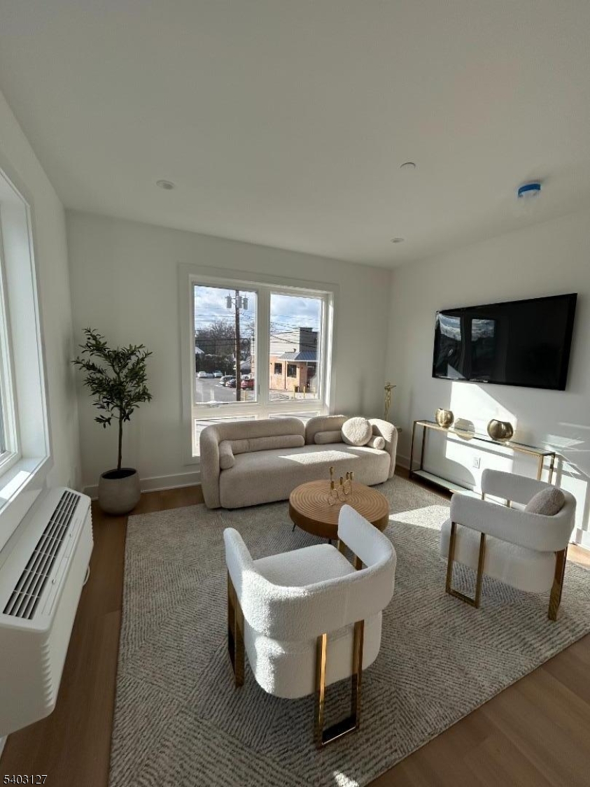1225 Morris Avenue, Unit 204 Union, NJ 07083 - Photo 5 of 12 a living room with furniture and a flat screen tv