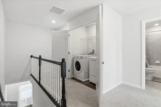 a view of a hallway with washer and dryer