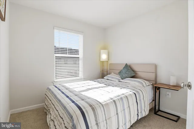 a bed sitting in a bedroom next to a window