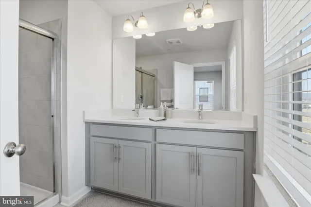 a bathroom with a double vanity sink and a mirror