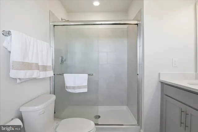 a bathroom with a shower a toilet and a sink