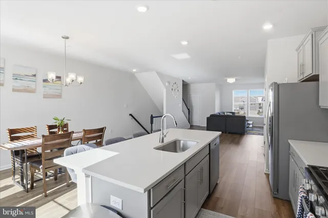 a kitchen with a dining table chairs and white cabinets