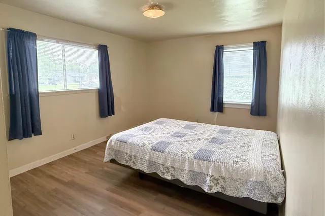 a bedroom with a bed and window