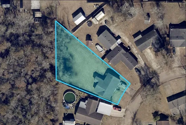 an aerial view of a house with a yard