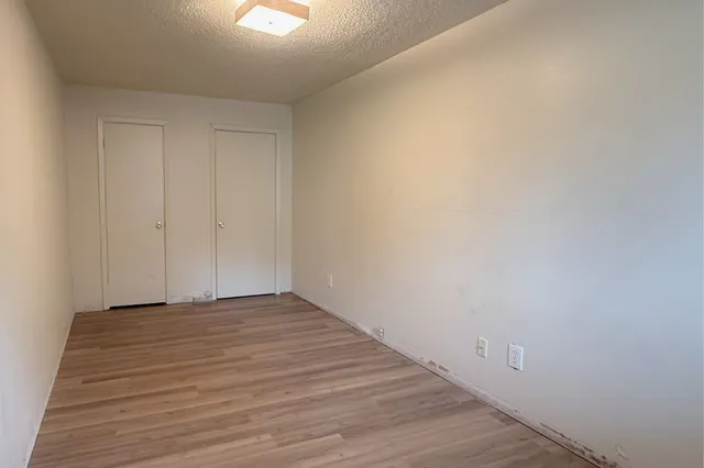a view of an empty room and wooden floor