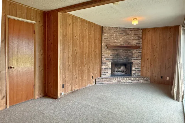 a view of an empty room with a fireplace