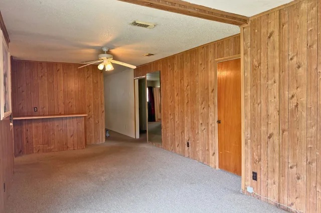 a view of a room with furniture and a ceiling fan