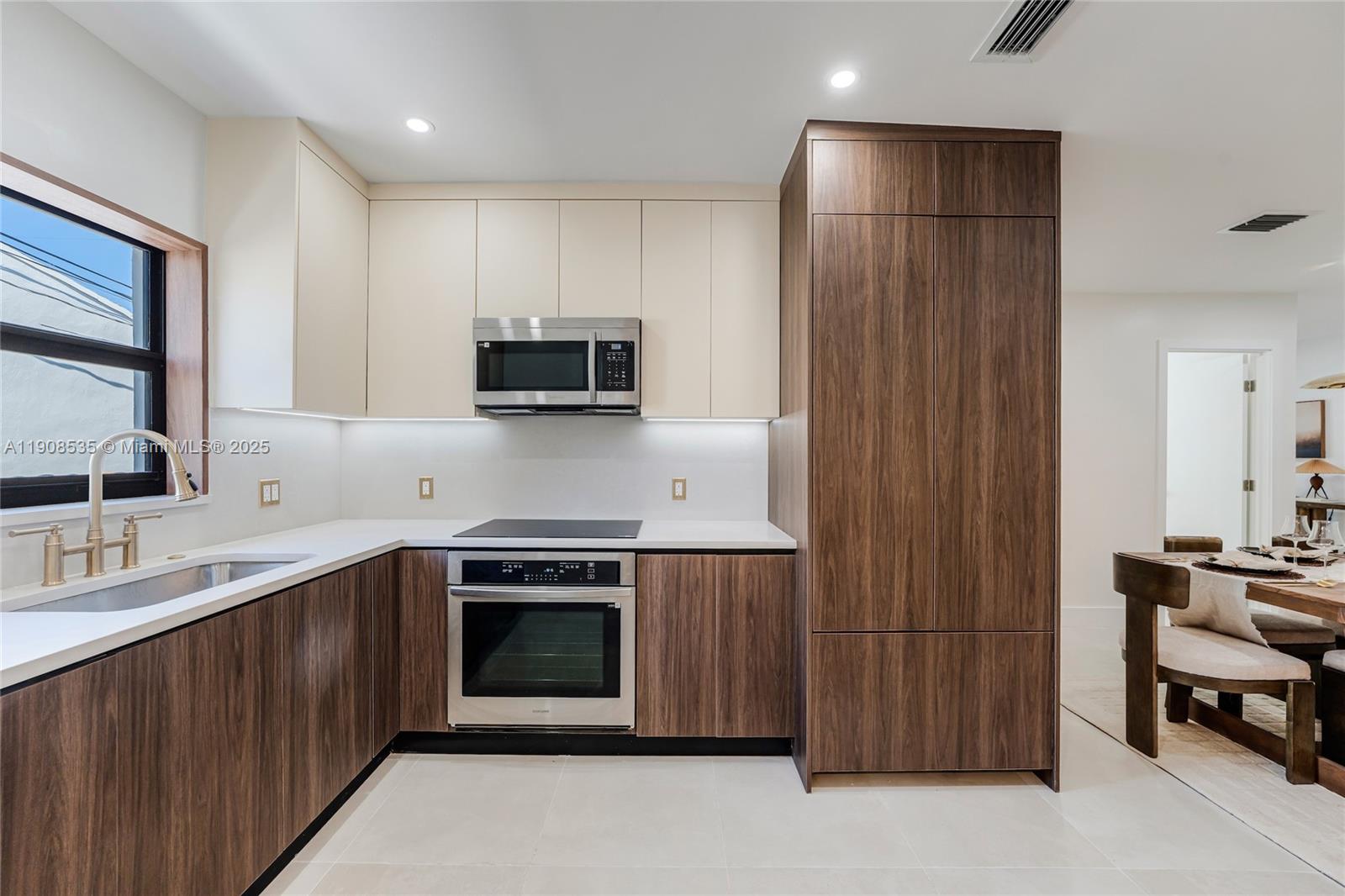 1244 Southwest 14th Street Miami, FL 33145 - Photo 13 of 63 a kitchen with stainless steel appliances a stove sink and microwave