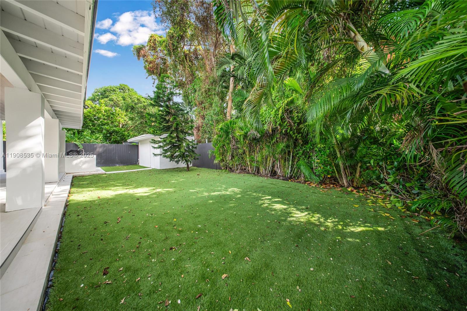 1244 Southwest 14th Street Miami, FL 33145 - Photo 60 of 63 a view of a yard with plants and a bench
