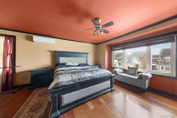 a bed room with a bed and a large window