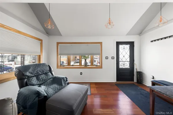 a living room with furniture window and wooden floor