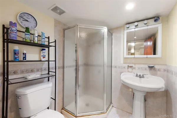 a bathroom with a toilet a sink and mirror