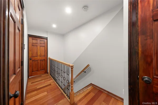 a view of a hallway with wooden floor and entryway