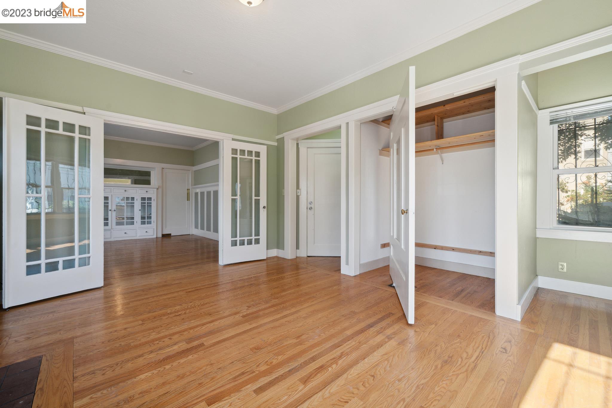 a view of empty room with wooden floor