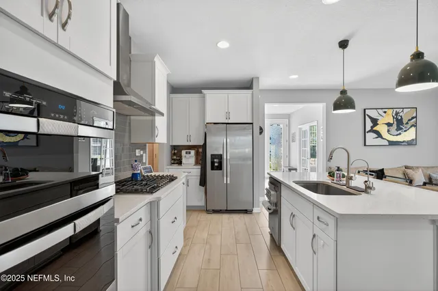 a kitchen with a sink stove and refrigerator