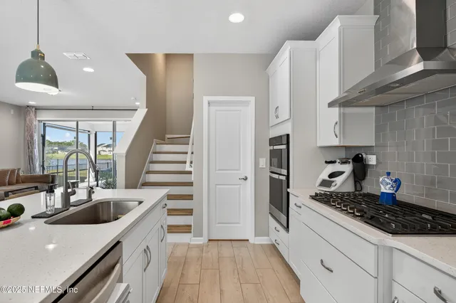 a kitchen with a sink a stove and refrigerator