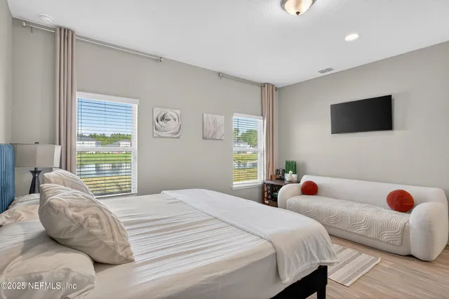 a bedroom with a bed and flat screen tv