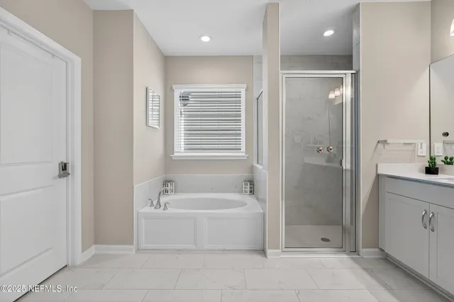 a bathroom with a bathtub and a shower