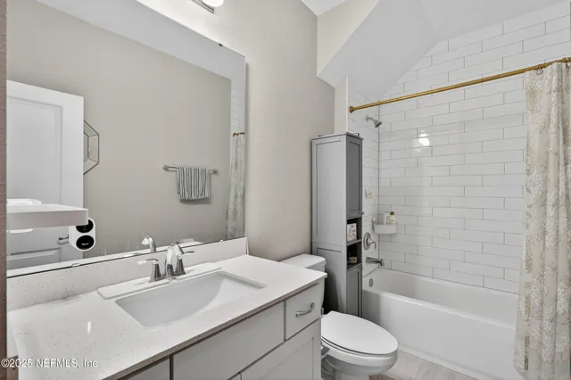 a bathroom with a sink toilet tub and shower