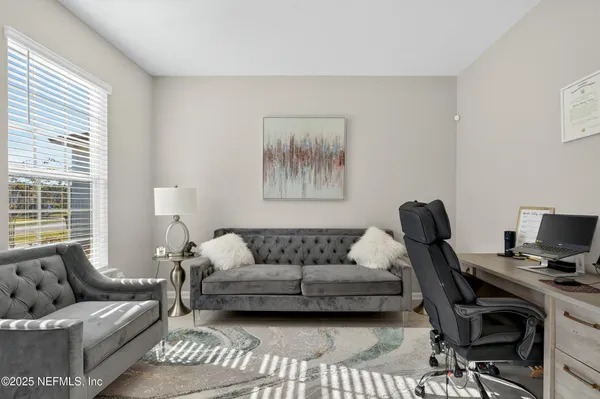 a living room with furniture and a window