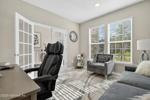 a living room with furniture a window and a flat screen tv