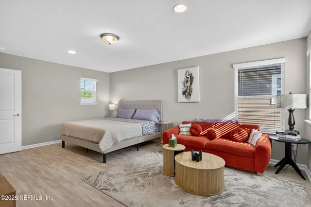 a bedroom with a bed and a couch