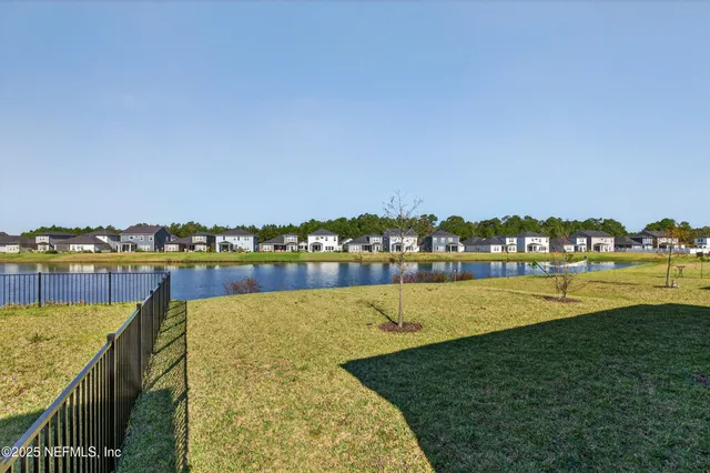 a view of a lake with houses in the back