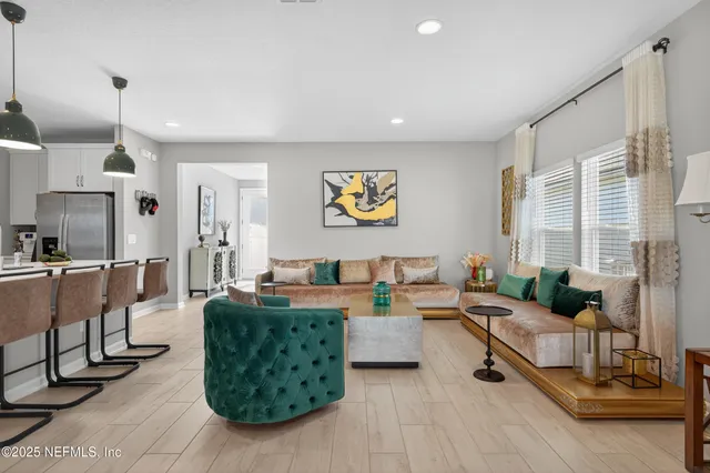 a living room with fireplace furniture and a large window