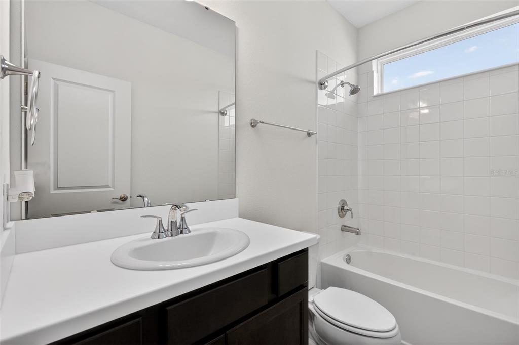 810 MIDDLETON Street DeBary, FL 32713 - Photo 44 of 52 a bathroom with a bathtub shower sink vanity mirror and toilet
