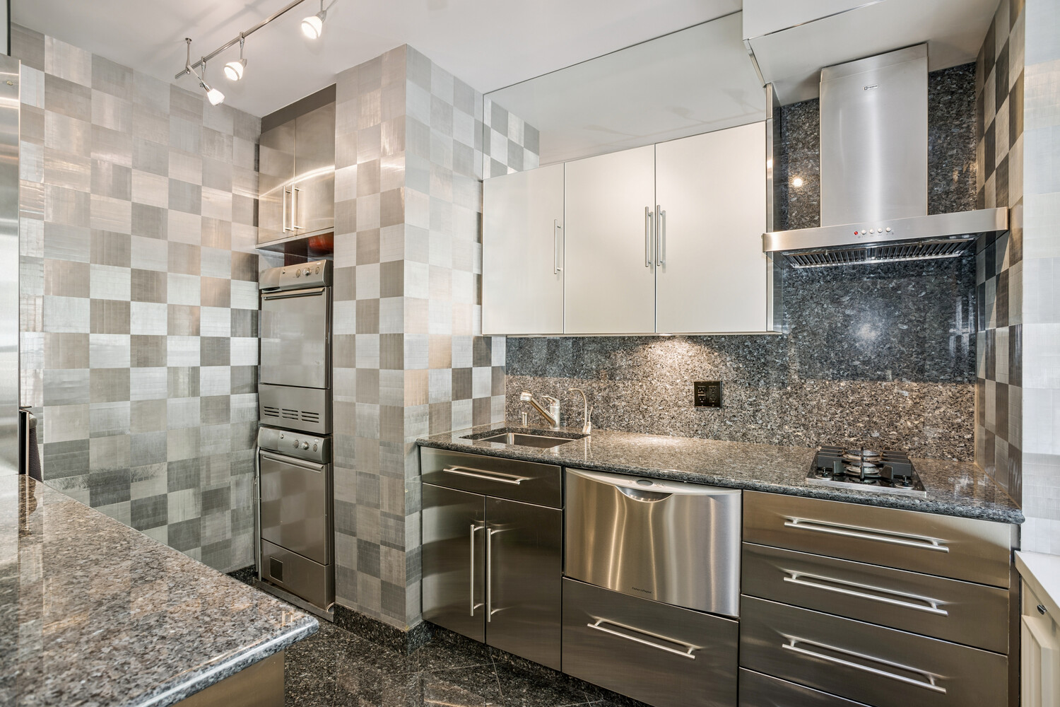 860 5th Avenue, Unit 2E Manhattan, NY 10065 - Photo 4 of 10 a kitchen with stainless steel appliances granite countertop a sink and a refrigerator