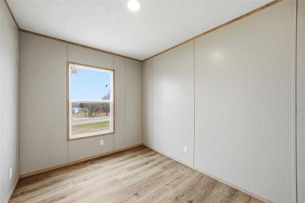 224 Derek Road Eddy, TX 76524 - Photo 15 of 24 an empty room with wooden floor and a window