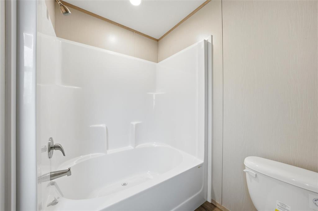 224 Derek Road Eddy, TX 76524 - Photo 17 of 24 a white bath tub sitting next to a white toilet