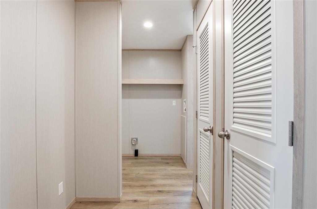 224 Derek Road Eddy, TX 76524 - Photo 19 of 24 a view of a hallway with wooden floor and staircase