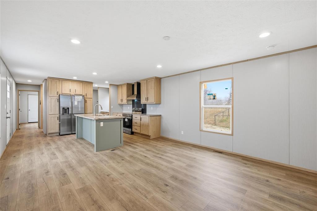 224 Derek Road Eddy, TX 76524 - Photo 10 of 24 a view of a kitchen with furniture and wooden floor