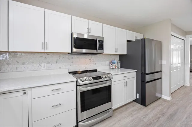a view of kitchen with wooden floor and window