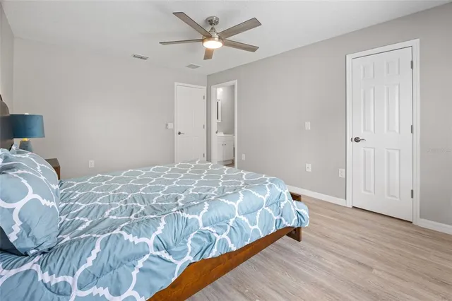 a bedroom with a bed and a painting on the wall