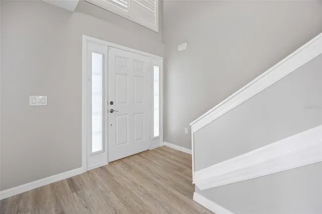 a view of an entryway with wooden floor
